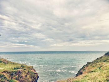 Scenic view of sea against cloudy sky