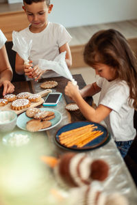 High angle view of kids preparing cookies at home