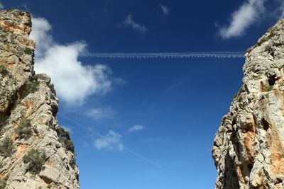 Low angle view of rock formation against sky