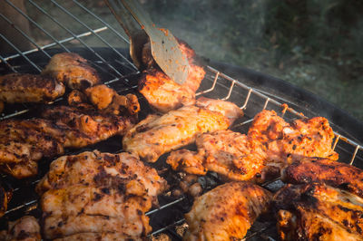 High angle view of meat on barbecue grill