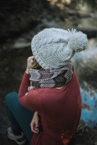 High angle view of woman sitting outdoors