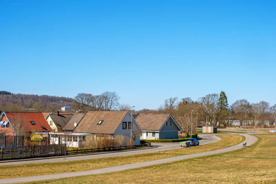 Street with a car and detached house in a swedish town