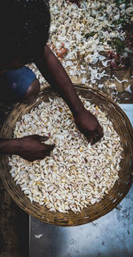 High angle view of person hand in container