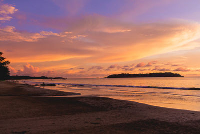 Scenic view of beach against sky during sunset