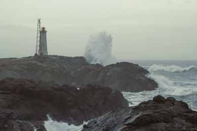 Stormy ocean and beacon landscape photo