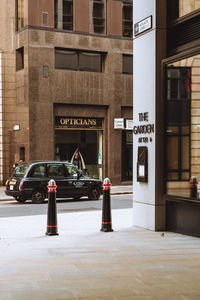 Cars parked on road against buildings in city