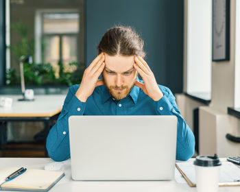 Focused male company employee trying to concentrate