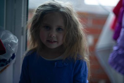 Adorable little girl against the large window
