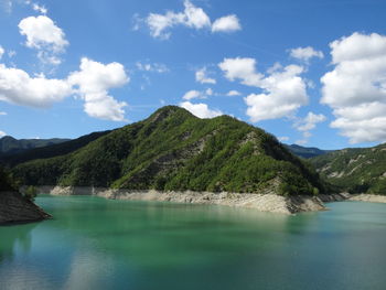 Scenic view of lake and mountains against sky