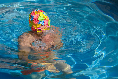 High angle view of man wearing swimming cap in pool