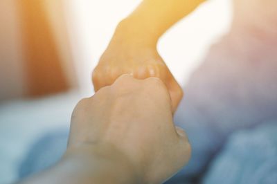 Cropped image of people giving fist bump