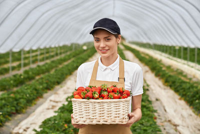 Portrait of young man holding ice cream in basket