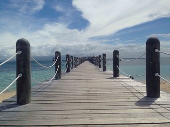 Pier over sea against sky