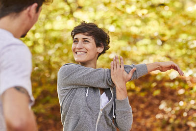 Couple stretching in forest