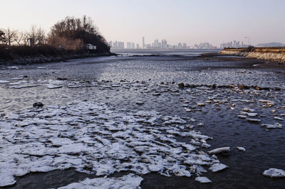 Scenic view of frozen river against sky