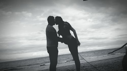 Silhouette of woman against cloudy sky