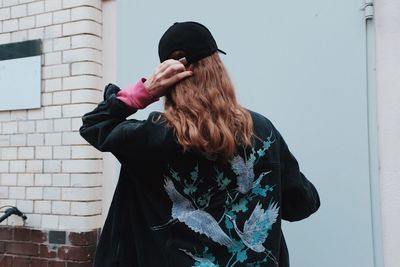 Woman standing against door