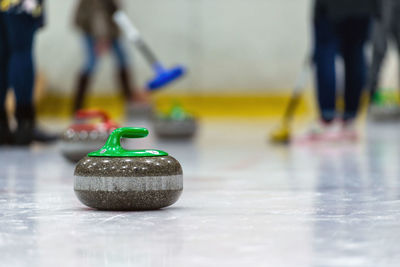 Low section of people playing curling on ice rink