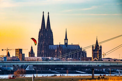 Bridge over river against buildings in city