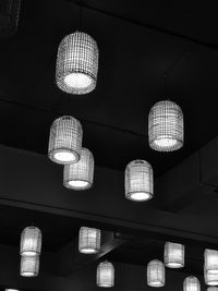 Low angle view of illuminated pendant lights hanging on ceiling