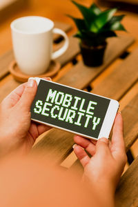 Midsection of person holding text on table