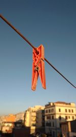 Low angle view of clothesline hanging on rope against sky