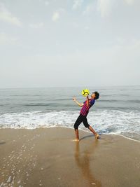 Full length of person on beach against sky