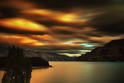 Scenic view of lake against cloudy sky