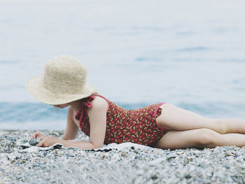 Girl playing with stones on beach