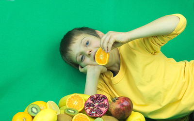 Portrait of man holding apple against blue background