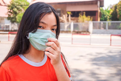 Portrait of a girl afraid of covid-19, girls are protected from viruses by wearing a mask