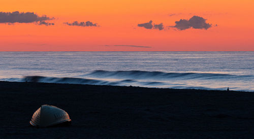 Scenic view of sea against orange sky