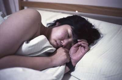 High angle view of woman lying on bed at home