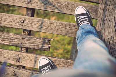 Low section of man standing on bench