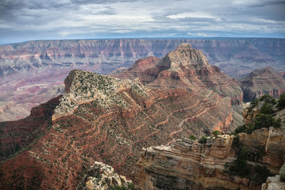 Scenic view of mountain range against cloudy sky