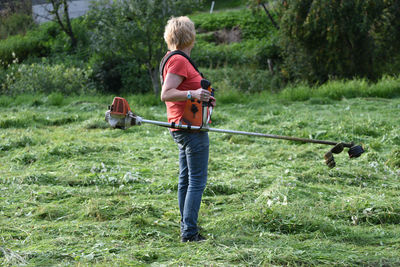 Rear view of man walking on field