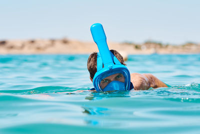 Portrait of man swimming in sea