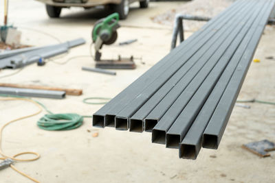 Closeup many steel bars with blurred background at the construction site.