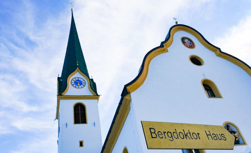 Low angle view of information sign against sky