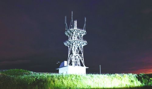 Close-up of sculpture on field against sky at night