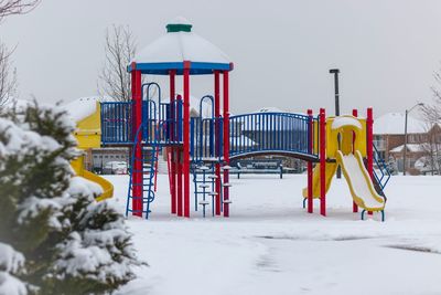 View of playground against clear sky during winter