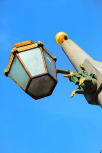 Low angle view of unicorn carving on lamp post against clear sky