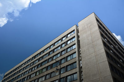 Low angle view of modern building against blue sky