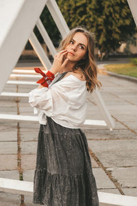 Portrait of a young woman standing outdoors