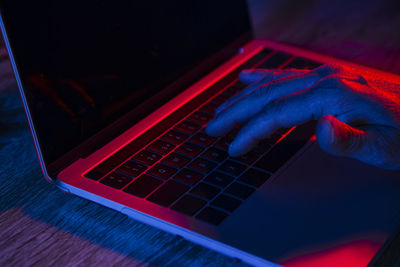 Close up of man's hand on laptop