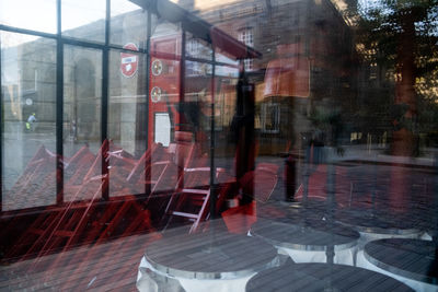 Reflection of buildings on wet glass window in rainy season