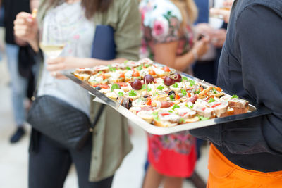 Midsection of people at market stall