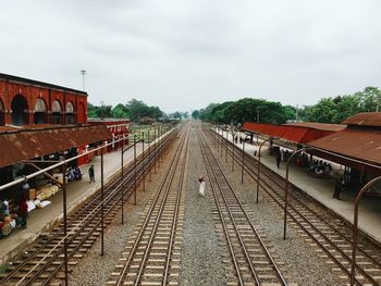 High angle view of man amidst railroad tracks at station