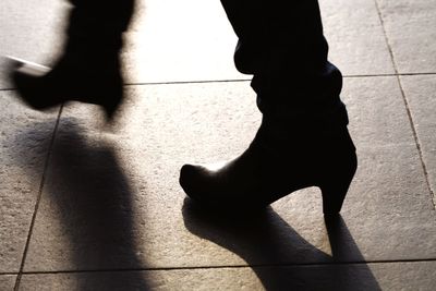 Low section of people standing on tiled floor