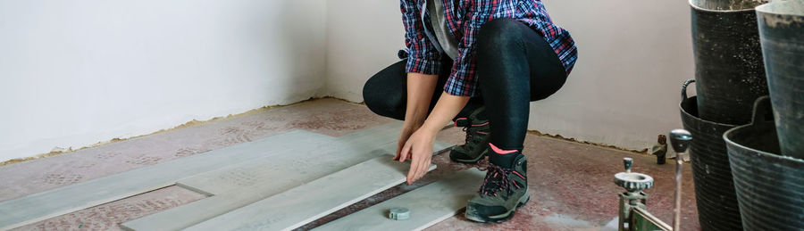 Low section of repairwoman working on site